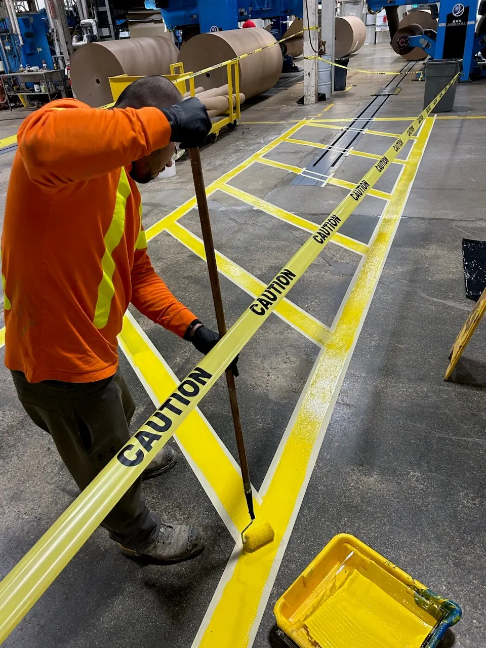 Zimcoat crew applying safety line marking over an epoxy coating